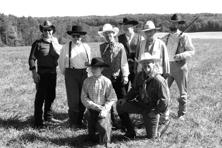 a group of people standing in a field