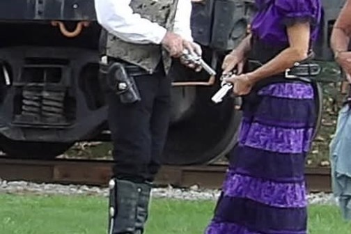 a group of people that are standing in the grass