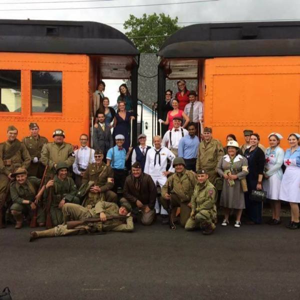 a group of people standing in front of a train