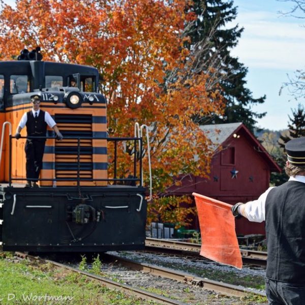 a man standing next to a train