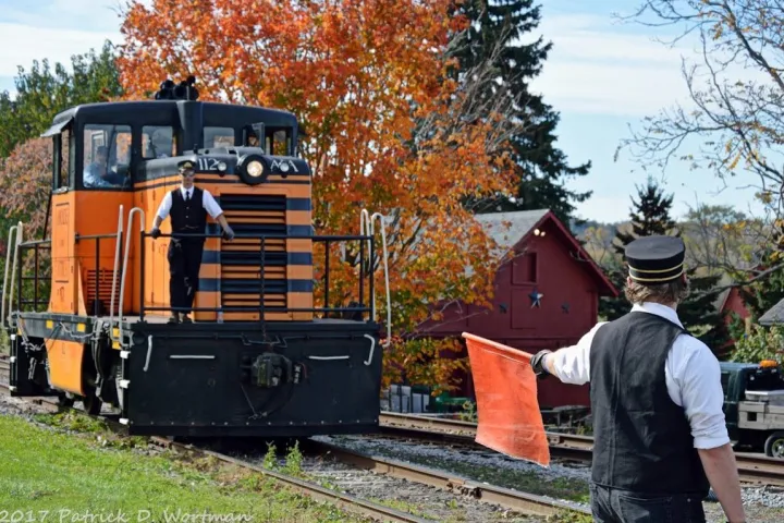 a man standing next to a train
