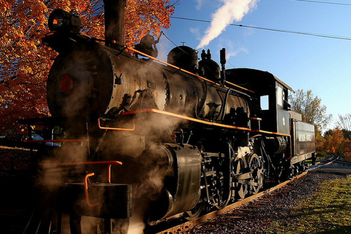 a steam engine is sitting on a train track