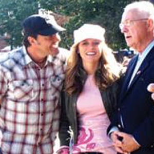 a group of people standing around each other