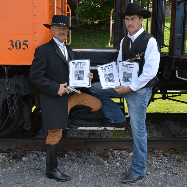 a group of people sitting on a bench reading a book