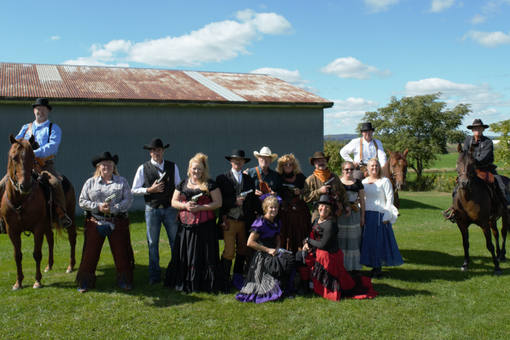 a group of people standing next to a horse