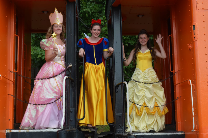 a girl in a dress standing in front of a building