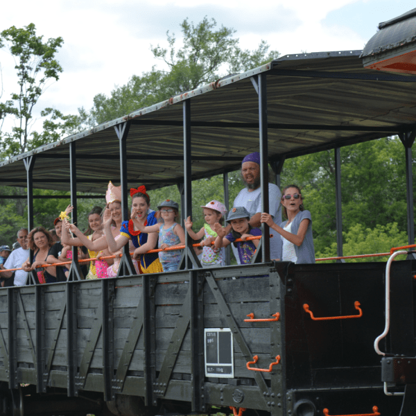 a group of people riding on the back of a train
