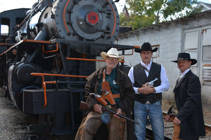 a group of people standing in front of a train