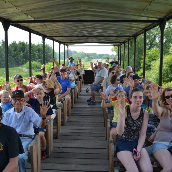 a group of people sitting around a wooden table