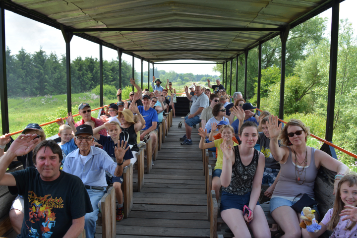 a group of people sitting around a wooden table