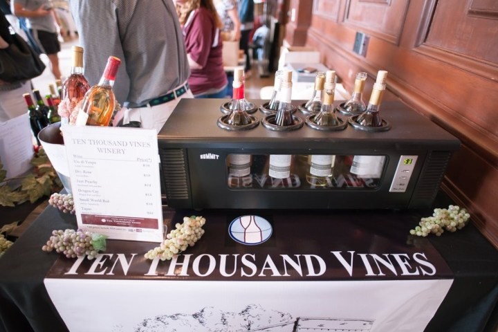 a group of people sitting at a table with a cake