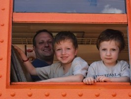 a little boy sitting in front of a window