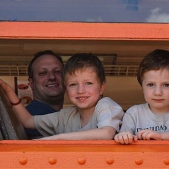 a little boy sitting in front of a window