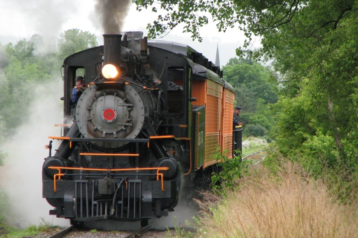 a train on a track with smoke coming out of it