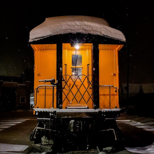 a train is parked on the side of a building