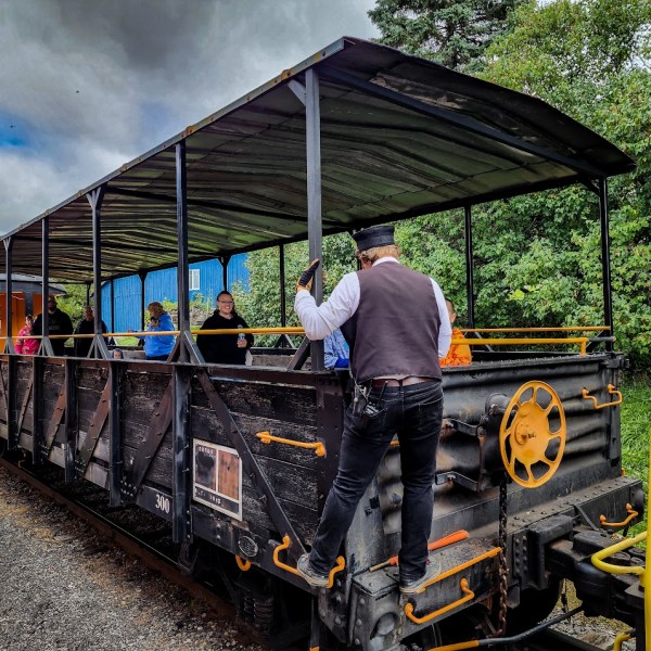 a man standing next to a train