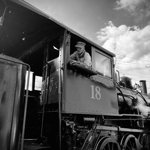 a train is parked on the side of a building