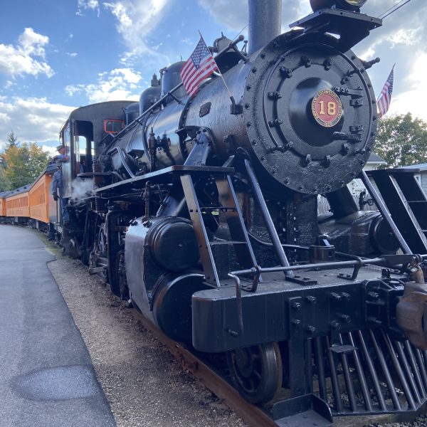 a steam engine is sitting on a train track