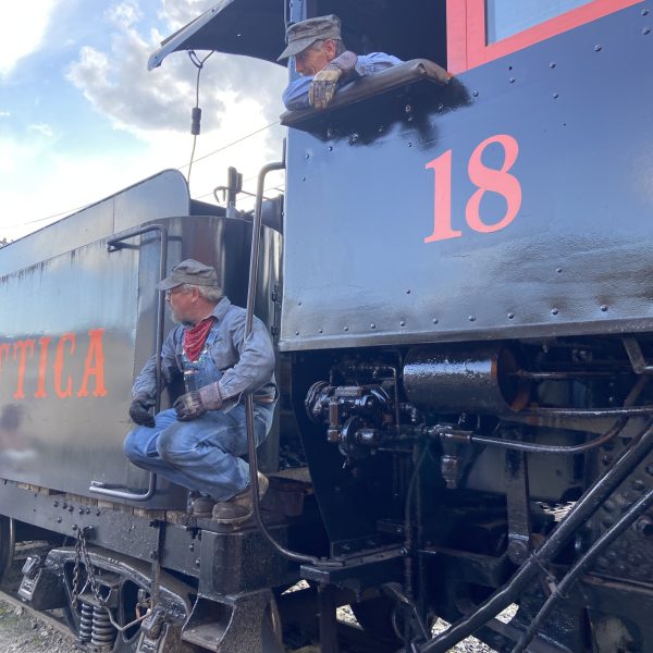 a person standing next to a train