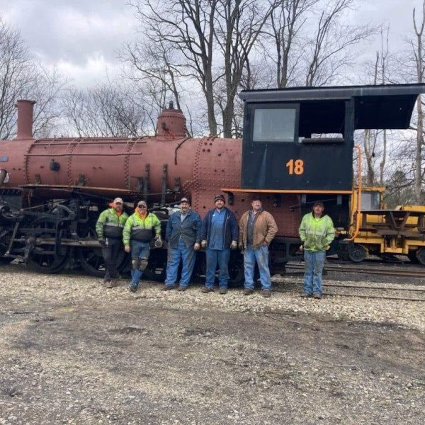 a group of people standing in front of a train