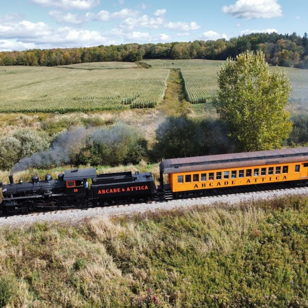 a train traveling down train tracks near a field