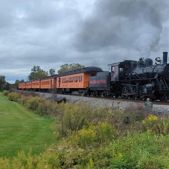 a steam train on a track with smoke coming out of it