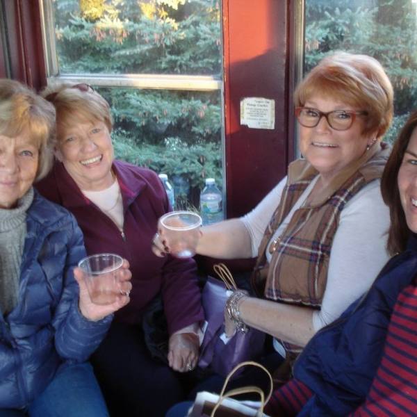 a group of people sitting at a table with wine glasses